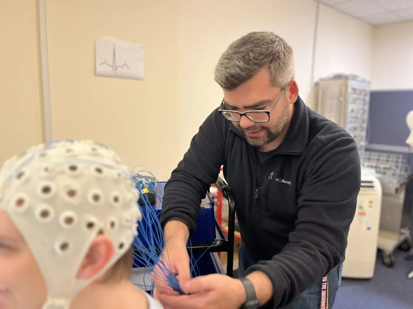 University of Portsmouth PhD student Benjamin Stocker setting up the EEG system on a participant.